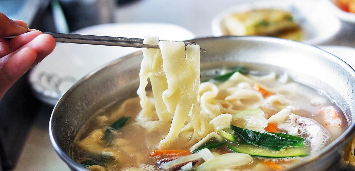 Kal-guksu. The noodle is flat and slightly uneven because it was cut from a rolled sheet, not extruded.